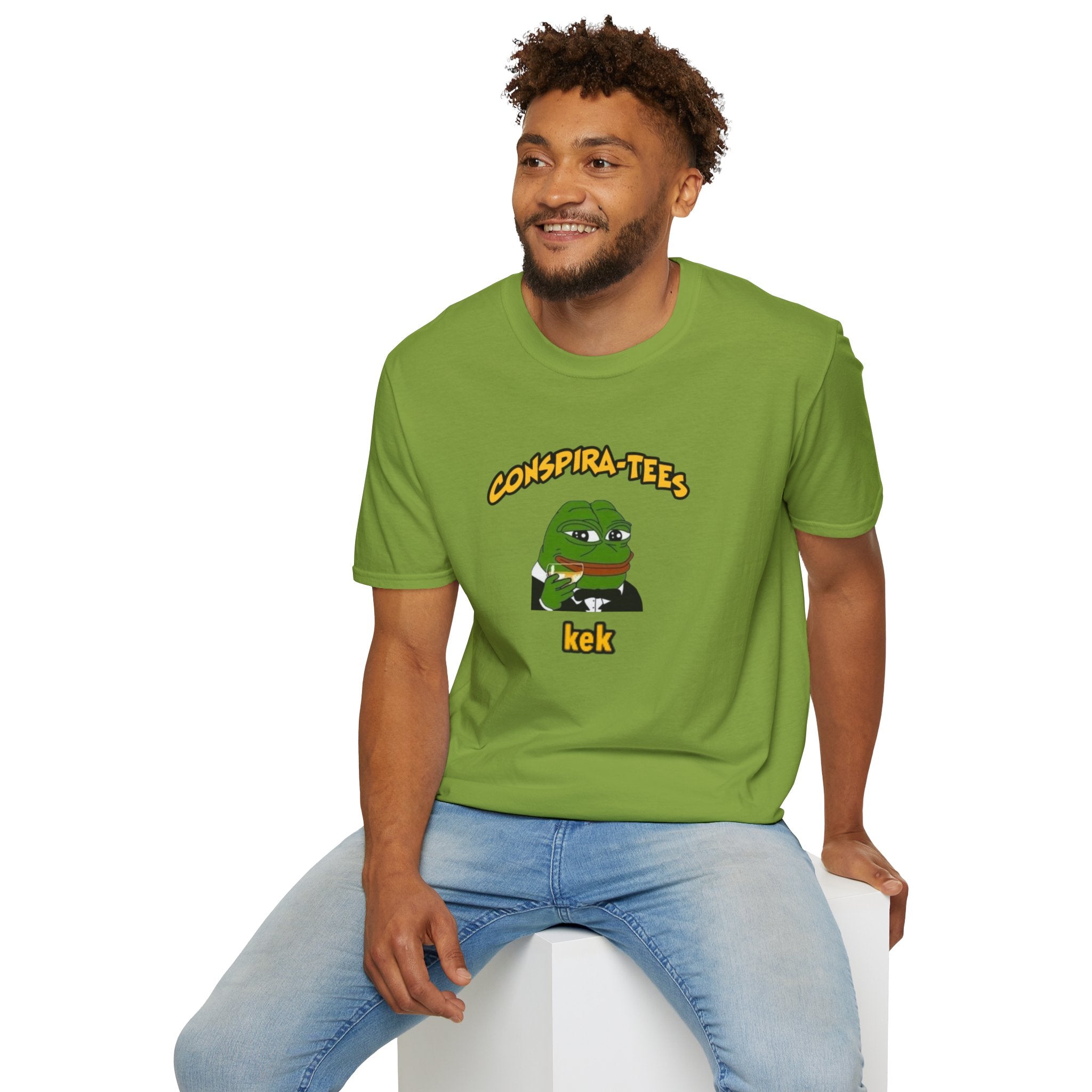 Kek Conspira-tee. Pepe at one point in time was the face of conspiracy memes on 4 chan and 8 chan. Kek is netspeak for lol. Mocking your enemy.