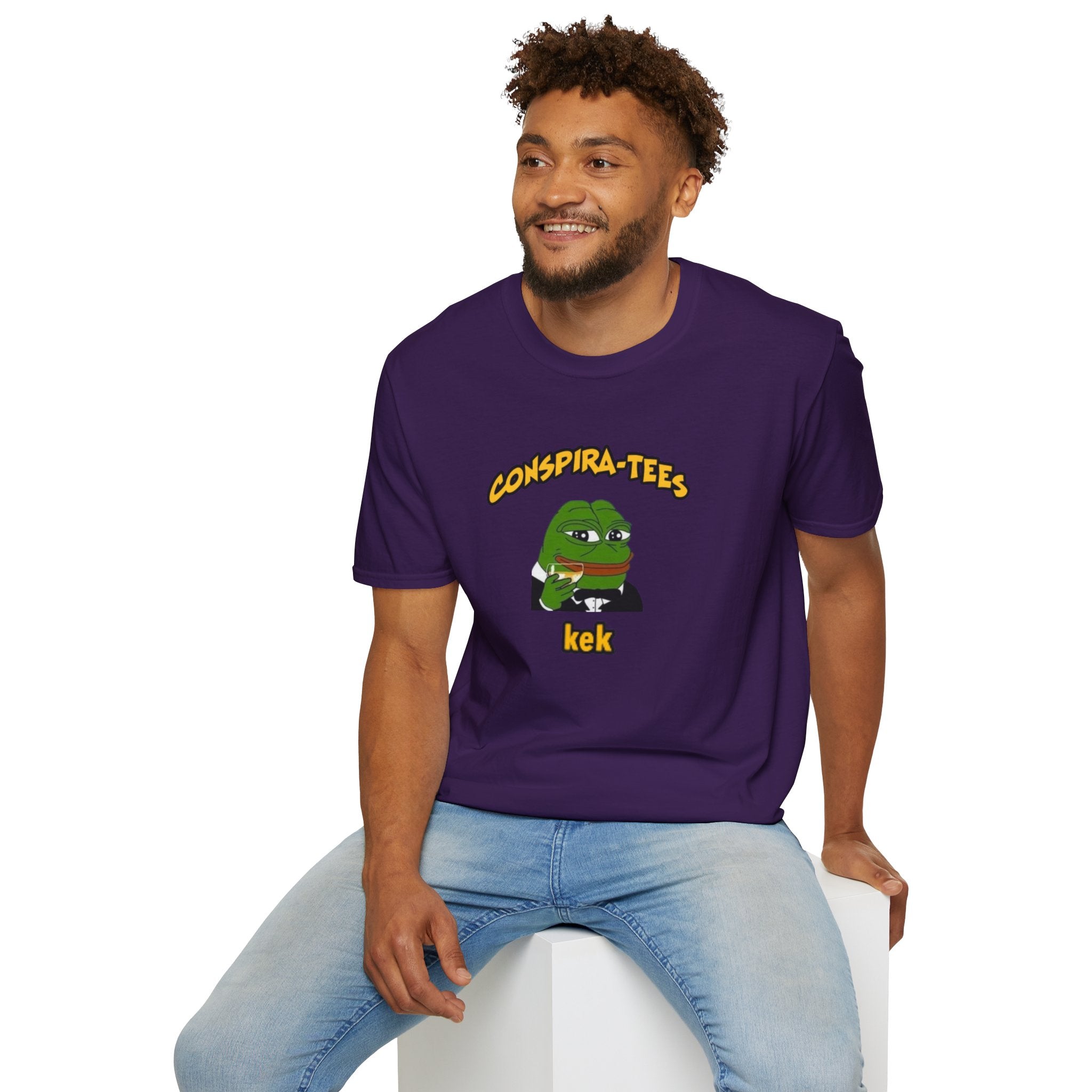Kek Conspira-tee. Pepe at one point in time was the face of conspiracy memes on 4 chan and 8 chan. Kek is netspeak for lol. Mocking your enemy.
