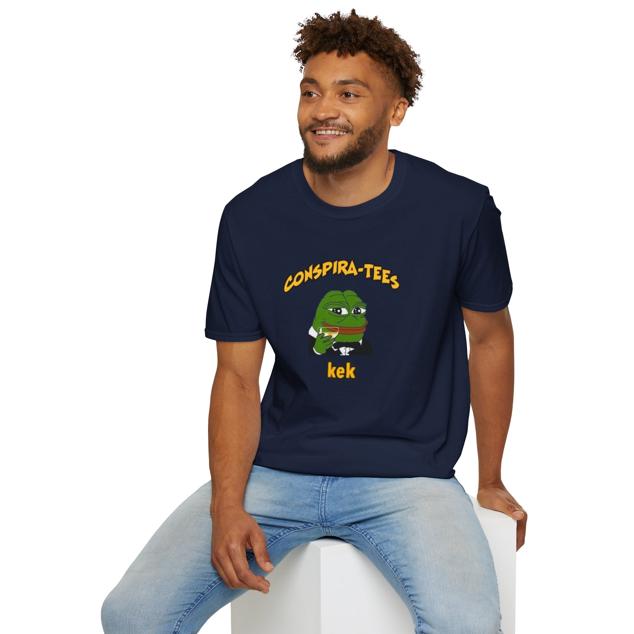 Kek Conspira-tee. Pepe at one point in time was the face of conspiracy memes on 4 chan and 8 chan. Kek is netspeak for lol. Mocking your enemy.